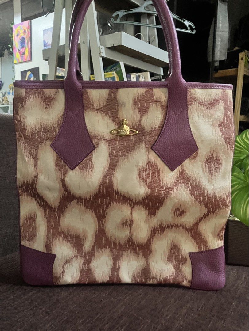 Vivienne Westwood (Category: Luxury Bags & Wallets) located in Quezon City. Submitted by retann (Listing ID 1465248335, Image 1). Description: -with Dustbag - like new condition - Design: Brown and beige animal print fabric with striking purple leather handles, trim, and corner patches - Iconic gold-tone orb logo centered on the front - Double top handles and a spacious interior for your daily essentials - medium in size.