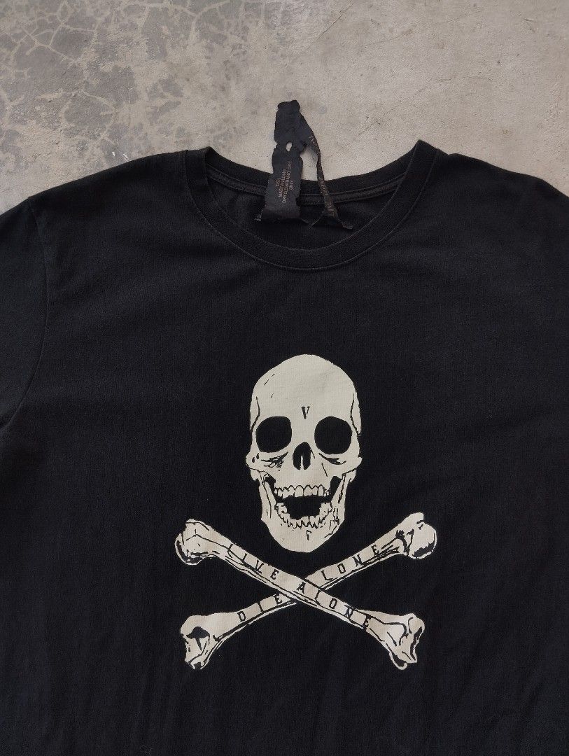 Vlone Skull Bones Graphic Tee Black Size L (Category: Tshirts & Polo Shirts ) located in Mati. Submitted by old_era.ph (Listing ID 1465172703, Image 3). Description: - Brand: Vlone - Color: Black - Size: Large (Regular fit) - Material: 100% cotton - Condition: Brand new with tags - Design: Front skull and crossbones with 'Live Alone Die Alone' text, signature large V graphic on the back - Authenticity: Includes neck tag and holographic wash tag -