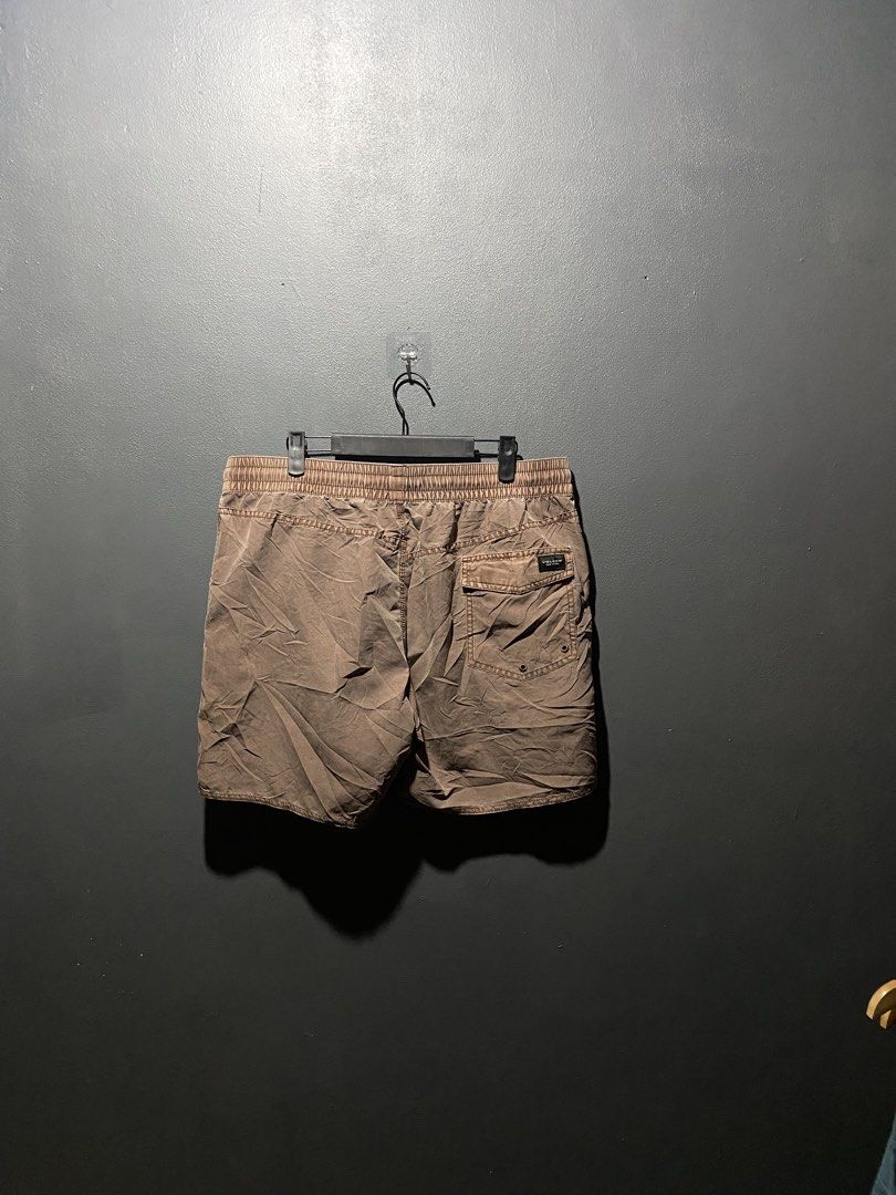 Volcom (Category: Swim Trunks & Board Shorts) located in Lucena. Submitted by handpickthrift (Listing ID 1465376803, Image 3). Description: Volcom shorts in brown with an elastic Size 32-35 waistband and drawstring closure. Features back patch pocket with velcro flap and brand logo patch. Includes circular Volcom stone patch near bottom hem. Regular fit, lightweight fabric. Great for casual wear, beach trips, or surfing..