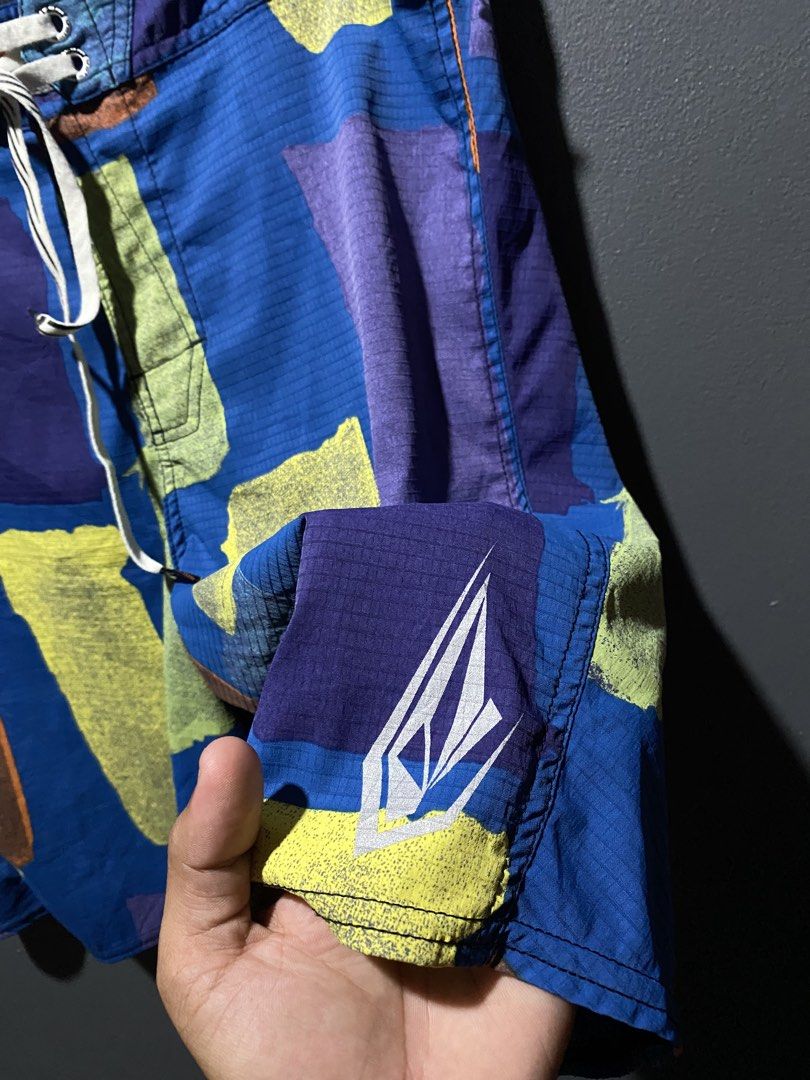 Volcom Amphibulator Technology Board Shorts Size 32 (Category: Swim Trunks & Board Shorts) located in Lucena. Submitted by handpickthrift (Listing ID 1465376828, Image 3). Description: - Brand: Volcom Size 32 - Technology: Amphibulator Technology with durable ripstop textured fabric - Design: Vibrant abstract brushstroke pattern in blue, purple, yellow, and orange with iconic stone logo - Features: Secure drawstring waist and handy zippered side 