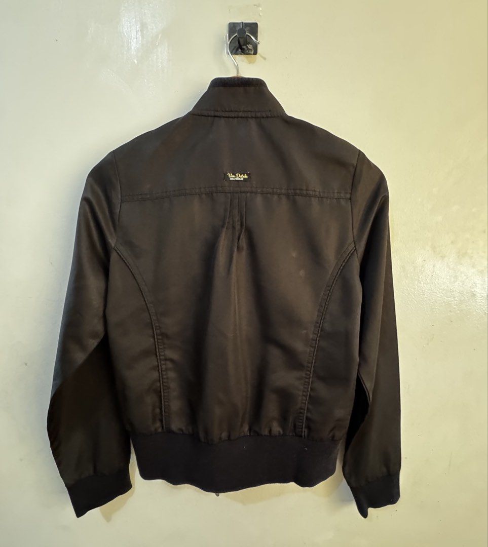 Von Dutch Black Studded Bomber Jacket Size M (Category: Coats, Jackets and Outerwear) located in Quezon City. Submitted by vibelane_shop (Listing ID 1465332794, Image 2). Description: Von Dutch black bomber jacket in size M. Features metal stud accents on the chest and shoulder epaulets. Ribbed collar, cuffs, and hem. Full zip closure with zipped pockets. Cotton-blend fabric with textured panels on the shoulders. Shows slight wear mark near the b