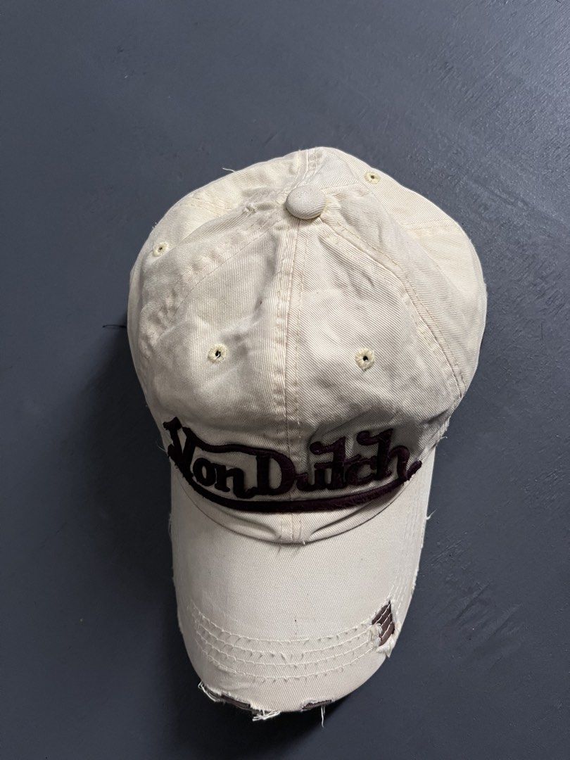 VON DUTCH DISTRESSED DESIGN (Category: Caps & Hats) located in Bacolod City. Submitted by johnkiercabungcal09 (Listing ID 1465235444, Image 2). Description: • Color: Cream / Beige with Dark Brown embroidery • Brand: Von Dutch Kustom Made Originals (authentic tag inside) • Logo: Raised embroidered “Von Dutch” front + “32” side patch • Style: Distressed / Rugged brim - intentional vintage look • Material: Twill cotton, soft • Size: One size / Adjus