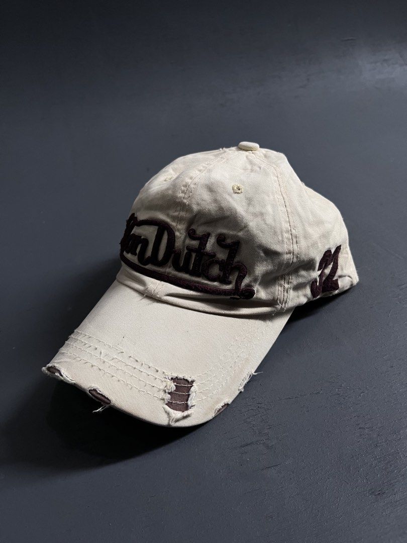 VON DUTCH DISTRESSED DESIGN (Category: Caps & Hats) located in Bacolod City. Submitted by johnkiercabungcal09 (Listing ID 1465235444, Image 1). Description: • Color: Cream / Beige with Dark Brown embroidery • Brand: Von Dutch Kustom Made Originals (authentic tag inside) • Logo: Raised embroidered “Von Dutch” front + “32” side patch • Style: Distressed / Rugged brim - intentional vintage look • Material: Twill cotton, soft • Size: One size / Adjus