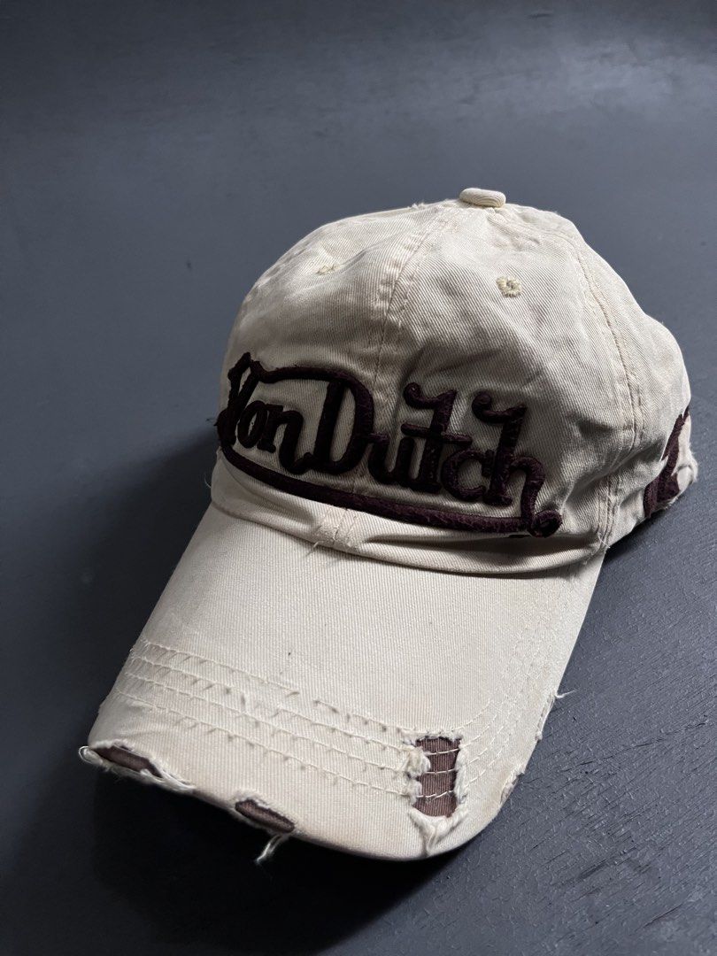 VON DUTCH DISTRESSED DESIGN (Category: Caps & Hats) located in Bacolod City. Submitted by johnkiercabungcal09 (Listing ID 1465235444, Image 3). Description: • Color: Cream / Beige with Dark Brown embroidery • Brand: Von Dutch Kustom Made Originals (authentic tag inside) • Logo: Raised embroidered “Von Dutch” front + “32” side patch • Style: Distressed / Rugged brim - intentional vintage look • Material: Twill cotton, soft • Size: One size / Adjus