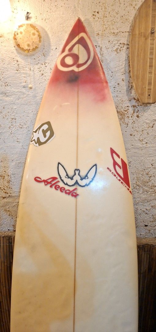 Webber 6'1 Surfboard (Category: Water Sports) located in Manila. Submitted by glydelmalu86312 (Listing ID 1465308973, Image 3). Description: - Brand/Model: Webber Surfboard - Size: 6'1 with a classic shape - Setup: Six-plug setup on the bottom, traction pad at the tail - Aesthetics: Red gradient nose spray and authentic stickers (Aleeda, Bouche) - Condition: Yellowing and pressure dents from regular use, 100% water-ready.