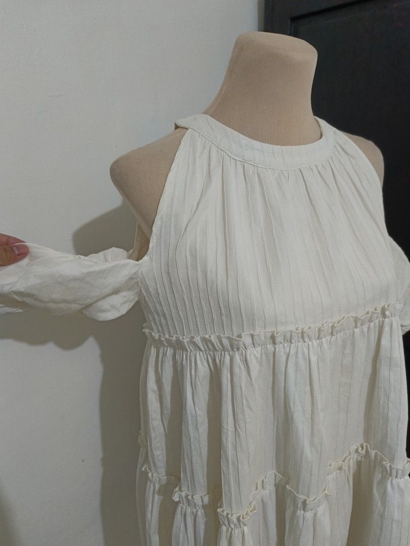 White Cold Shoulder Tiered Ruffle Dress (Category: Dresses) located in Cabanatuan. Submitted by lyxyx (Listing ID 1465308665, Image 3). Description: - Color: White - Style: Cold shoulder cutouts with short sleeves and round neckline - Fit: Relaxed, flowy, and easy to throw on - Fabric: Textured with subtle vertical stripes - Details: Cute ruffle trim along the tiered sections - Vibe: Light, breezy, and perfect for warm weather.