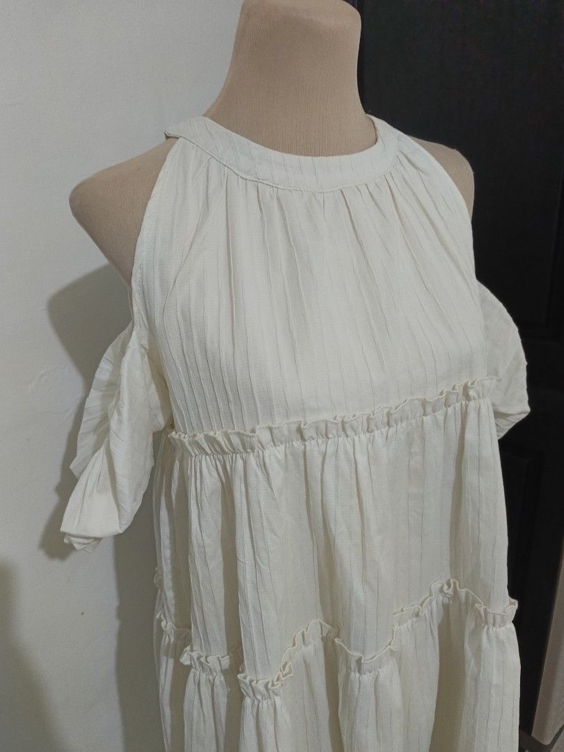 White Cold Shoulder Tiered Ruffle Dress (Category: Dresses) located in Cabanatuan. Submitted by lyxyx (Listing ID 1465308665, Image 2). Description: - Color: White - Style: Cold shoulder cutouts with short sleeves and round neckline - Fit: Relaxed, flowy, and easy to throw on - Fabric: Textured with subtle vertical stripes - Details: Cute ruffle trim along the tiered sections - Vibe: Light, breezy, and perfect for warm weather.