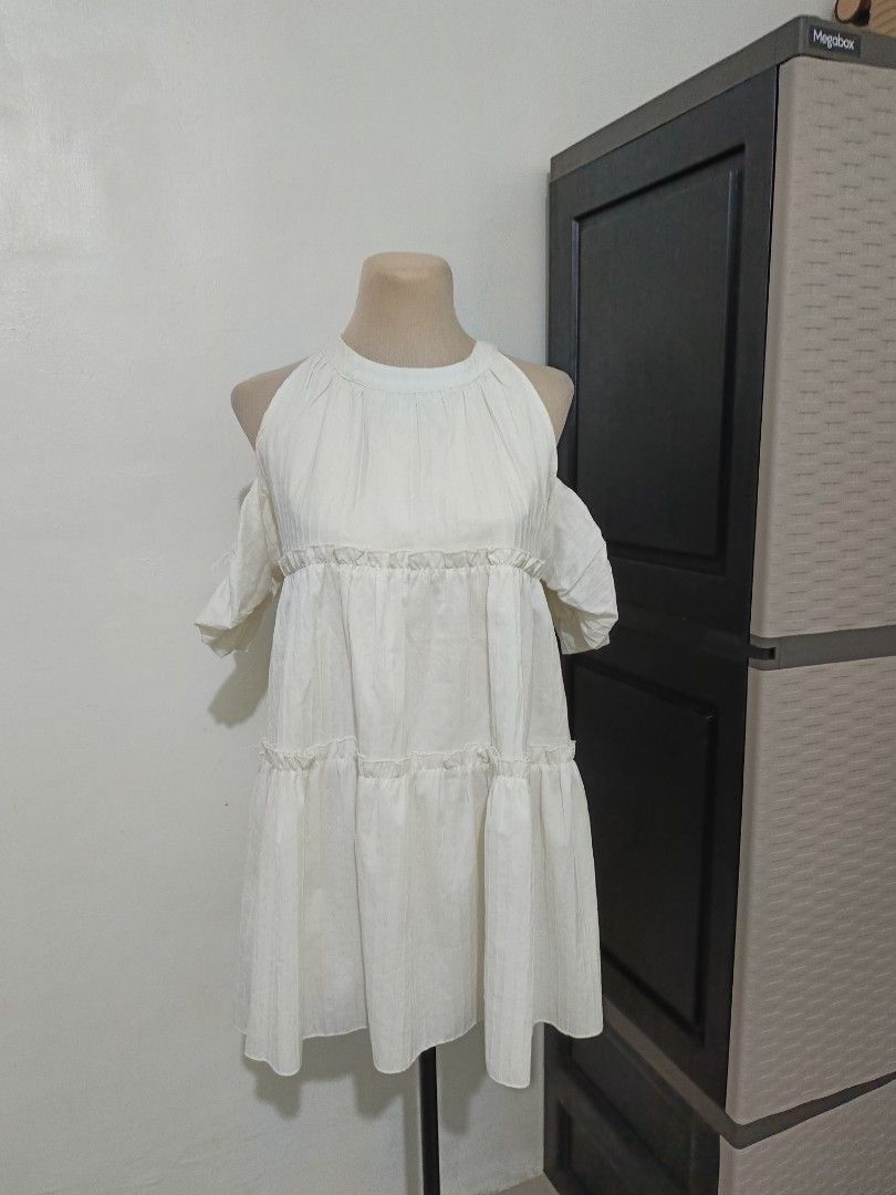 White Cold Shoulder Tiered Ruffle Dress (Category: Dresses) located in Cabanatuan. Submitted by lyxyx (Listing ID 1465308665, Image 1). Description: - Color: White - Style: Cold shoulder cutouts with short sleeves and round neckline - Fit: Relaxed, flowy, and easy to throw on - Fabric: Textured with subtle vertical stripes - Details: Cute ruffle trim along the tiered sections - Vibe: Light, breezy, and perfect for warm weather.
