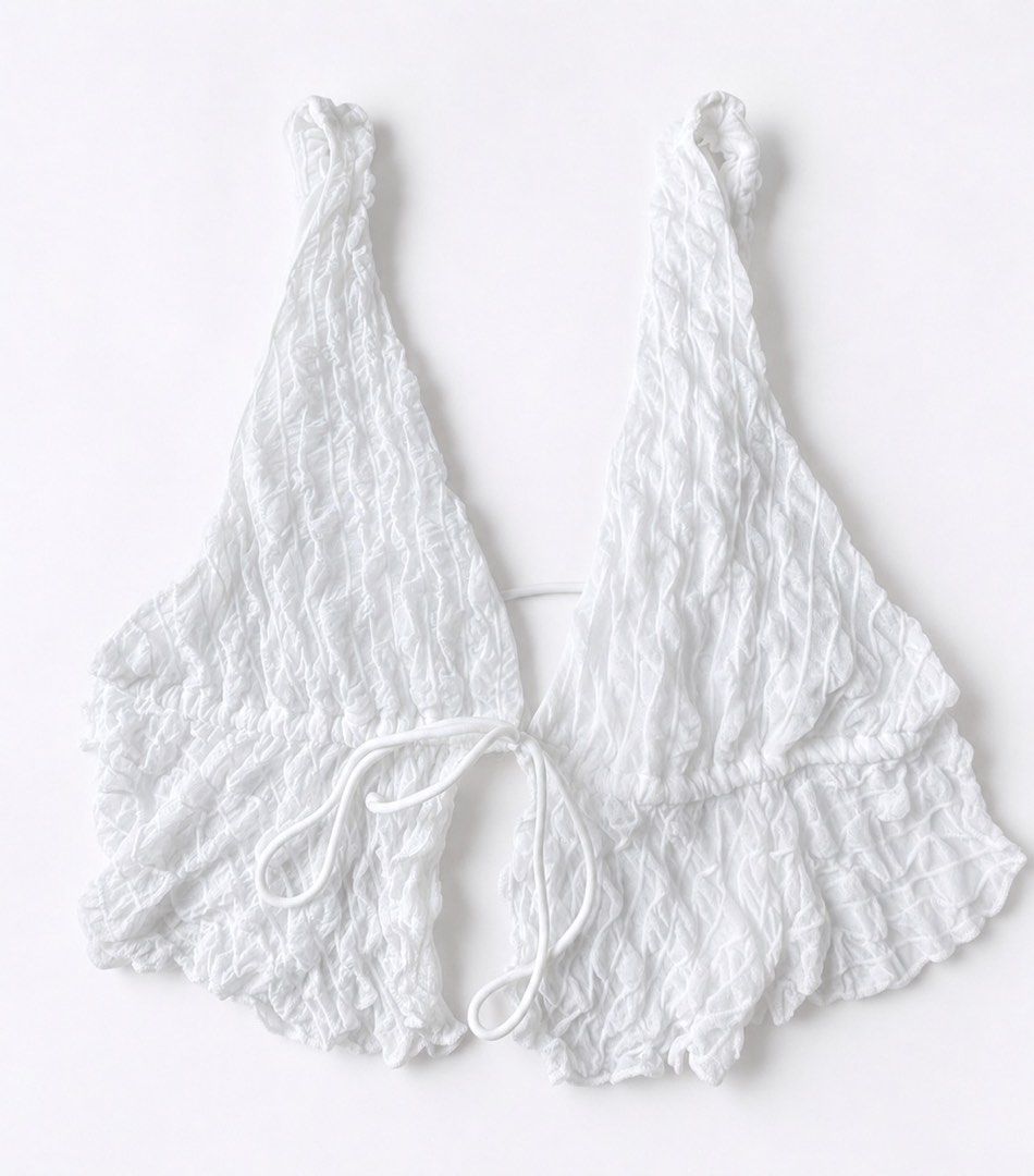 White crinkle texture halter crop top with front tie (Category: Sleeveless) located in Manila. Submitted by ynaamo (Listing ID 1465264756, Image 1). Description: White sleeveless crop top featuring a crinkled texture, deep V-neckline, halter straps, and a front tie closure. Made from soft, stretchy fabric and pairs perfectly with high-waisted bottoms..