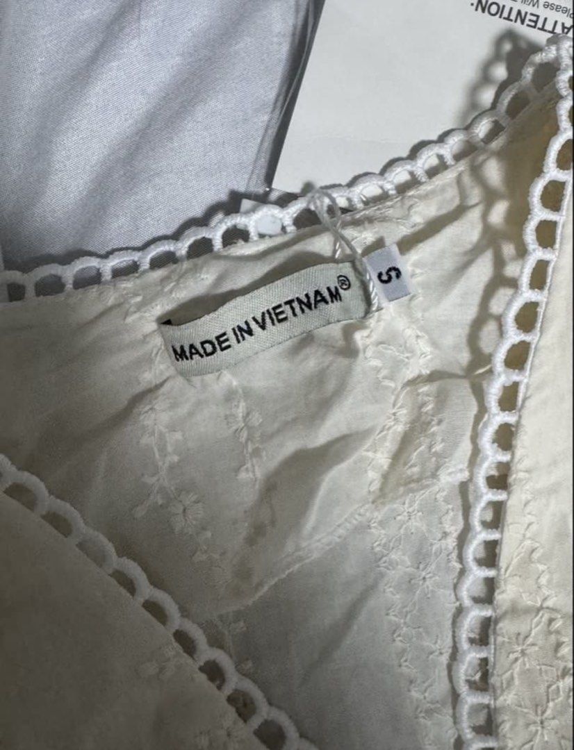 White Embroidered V-Neck Button-Up Blouse (Category: Blouses) located in Manila. Submitted by itsmerawrs (Listing ID 1465313520, Image 2). Description: - Condition: Brand new with tags attached (BNWT) - Size: Small (S) - Color: Classic White - Design: All-over delicate floral embroidery with a V-neckline - Details: Scalloped trim on the V-neck, sleeves, and hem - Fit: Fitted waist with a stylish flared peplum silhouette.