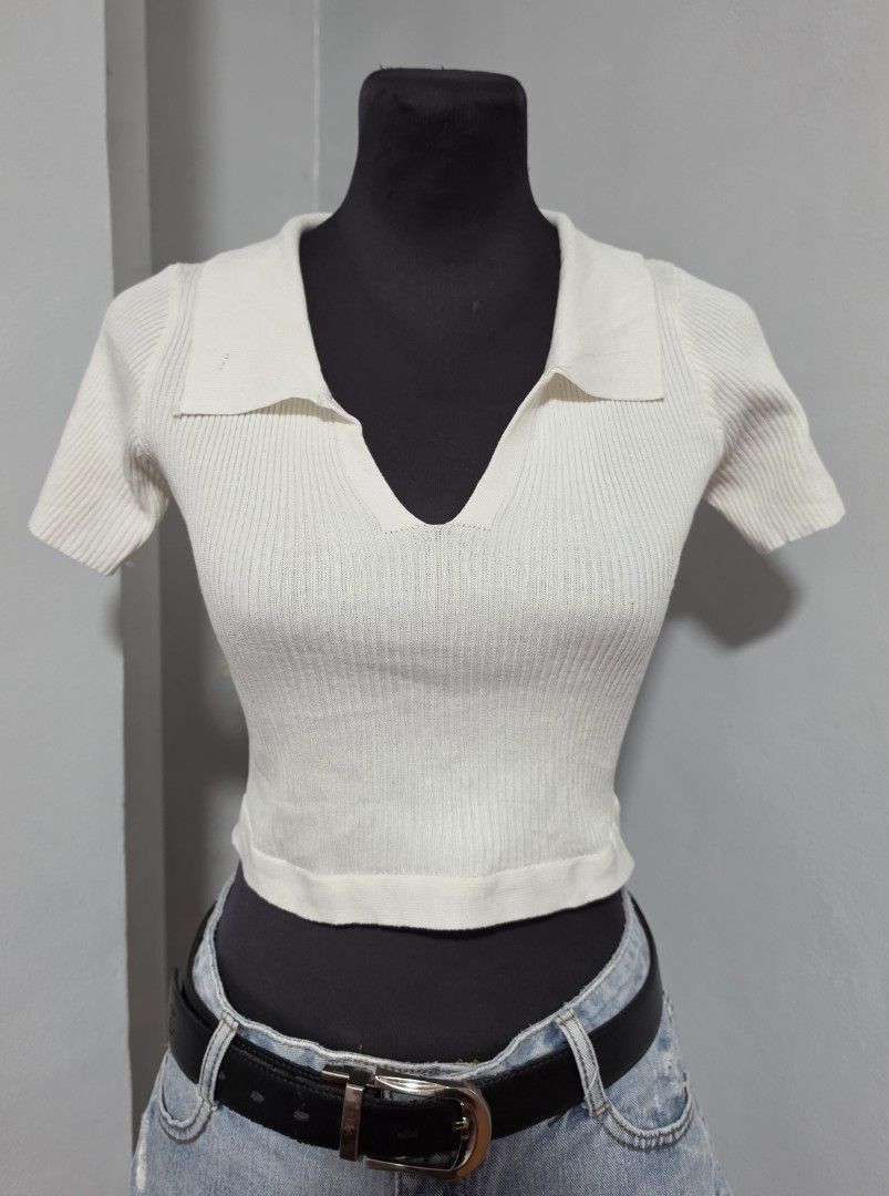 White Knitted Crop Top with Collar and Back Tie (Category: Blouses) located in Paranaque City. Submitted by franinnashop (Listing ID 1465310494, Image 1). Description: DECLUTTER SMALL TO MED PARANAQUE CITY - White ribbed knit crop top - V-neck collar with short sleeves - Back keyhole opening with tie-up ribbon detail - Stretchy and lightweight material - Flaw note: Small brownish spot on right collar and faint yellow stain on back tie strap.