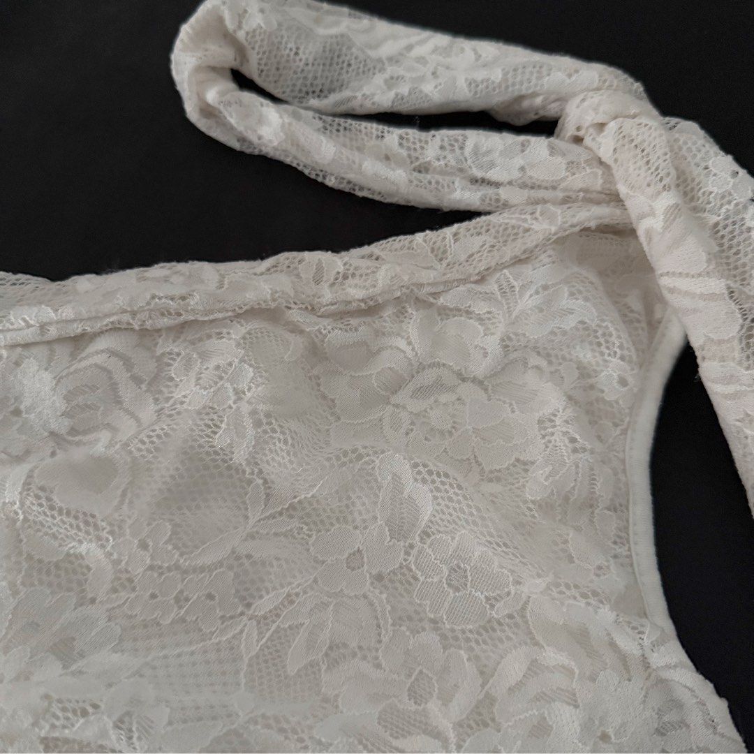 White Lace One-Shoulder Halter Top (Category: Sleeveless) located in Manila. Submitted by jhoysfabcloset (Listing ID 1465236635, Image 3). Description: - Style: White lace one-shoulder top with asymmetric neckline - Detail: Features an all-over floral lace pattern and a matching neck tie strap - Versatility: Pairs effortlessly with a black skirt for chic evening outings - Condition: Brand new / Excellent (ready to wear) - Mode of Payment: GCash, 