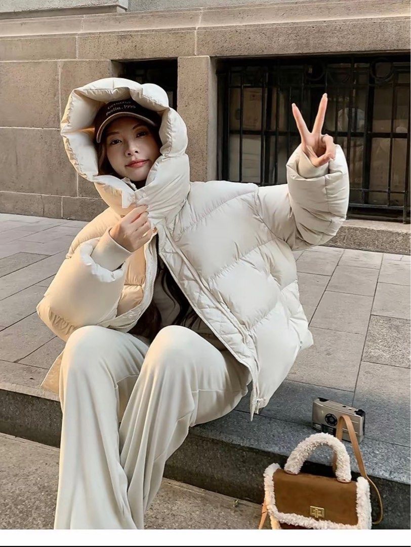 White puffy winter jacket with large hood (Category: Coats, Jackets and Outerwear) located in Manila. Submitted by randomstuffiown (Listing ID 1465350523, Image 2). Description: - Color: Off-White - Super cozy quilted padding, perfect for cold days - Big oversized hood to block the wind - Dual closure: Front zipper and snap buttons - Adjustable drawstrings at the hem - Convenient pockets on both sides - Soft material, easy to layer over sweaters.