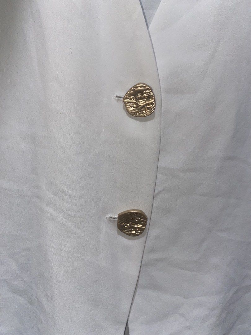 White Short Sleeve V-Neck Top (Category: Blouses) located in Rizal. Submitted by bypc5678 (Listing ID 1465359367, Image 2). Description: - Med to Large - Details: Elegant gold front buttons - Material: polyester - Size: Medium (tag attached).