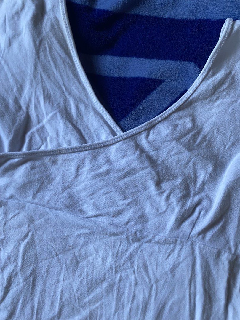 White Wrap Front Short Sleeve Tee V-Neck Top (Category: Shirts) located in Caloocan City. Submitted by lienzonius (Listing ID 1465382850, Image 2). Description: - Color: White - Style: Short sleeve wrap-around front with V-neckline - Material: Soft, comfortable cotton - Versatility: Easy to match with any jeans or skirts - Condition: Clean and well-kept.