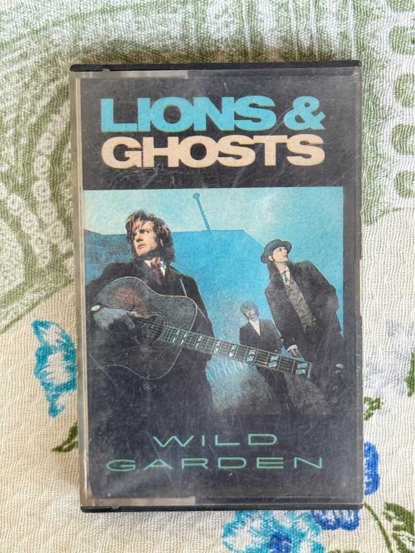 Wild Garden Lions & Ghosts Cassette Tape (Category: CDs & DVDs) located in San Juan City. Submitted by redgecollection (Listing ID 1465233736, Image 1). Description: Wild Garden Lions & Ghosts cassette tape album. Tracklist includes Arson In Toyland, Five & Dime, Farewell In Hell, Too Shy, Flowers Of Evil, American Ghost, Capture, Mermaid, Hourglass, Mr. Blue Sky. Distributed by Dyna Products, Inc. under license from Capitol Records. Classic 80s 