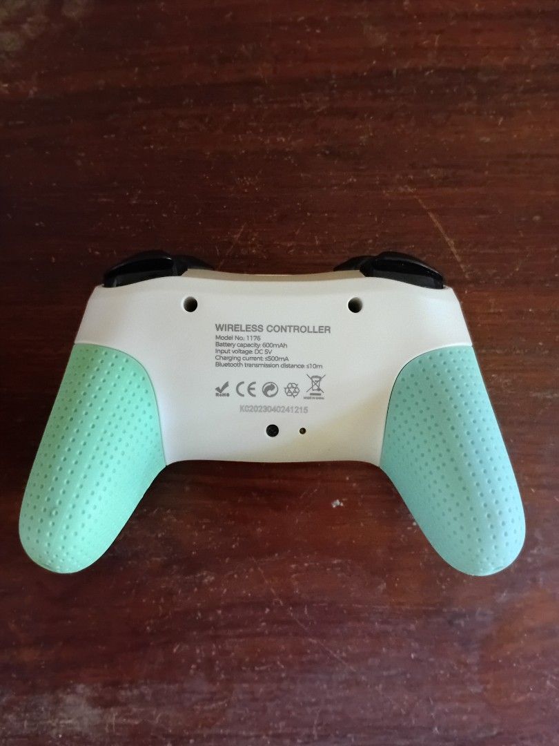 Wireless Controller for Nintendo Switch with Mint Green Grips (Category: Controllers) located in Don Carlos. Submitted by aspect_ratio (Listing ID 1465179222, Image 2). Description: - Compatible with Nintendo Switch - Color: White with mint green textured grips - Features: Built-in 6-axis gyro, double motor vibration, and LED - Inclusions: Original box, USB-C charging cable, and extra interchangeable thumbstick caps - Perfect upgrade for your gam