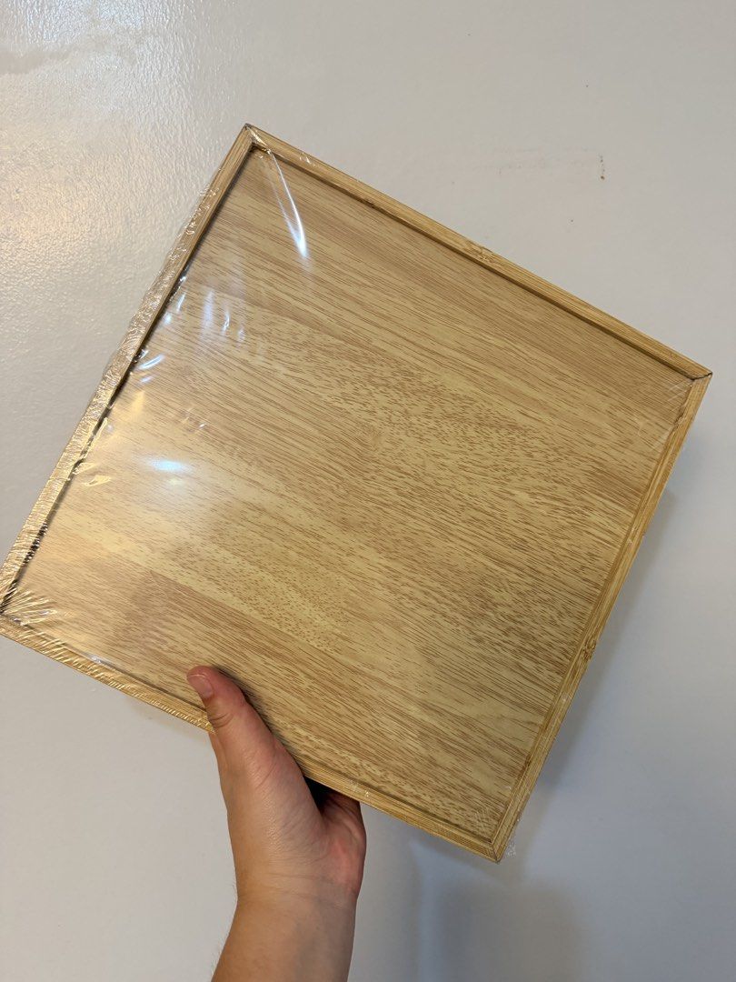 Wooden 9-Grid Compartment Snack Tray (Category: Food Organization & Storage) located in Caloocan City. Submitted by prettylittleboo (Listing ID 1465178060, Image 2). Description: - Brand new, never opened, still sealed in original plastic wrap - Square wooden serving tray with 9 built-in compartments - Ideal for organizing snacks, nuts, dried fruits, and party treats - Made from sturdy, high-quality natural wood grain - Features a smooth, clean f