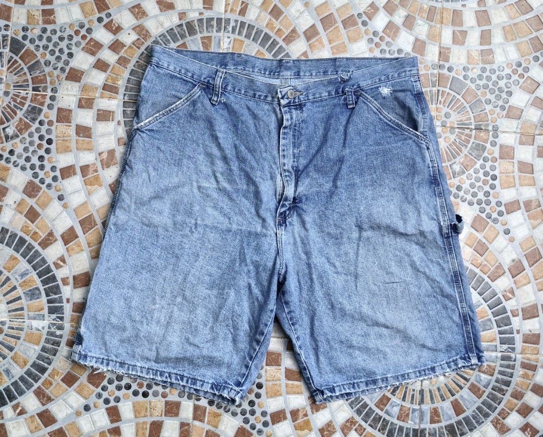 Wrangler Carpenter Denim Shorts Size 38 (Category: Shorts) located in Quezon. Submitted by miksxthrift (Listing ID 1465341802, Image 1). Description: - Brand: Wrangler - Style: Carpenter denim shorts - Color/Wash: Light wash blue - Size: Tagged 38 - Material: 100% cotton, Made in Mexico - Closure: Button fly - Features: Multiple utility pockets, left leg hammer loop, iconic woven back pocket label - Condition: Natural fraying and distressed spots
