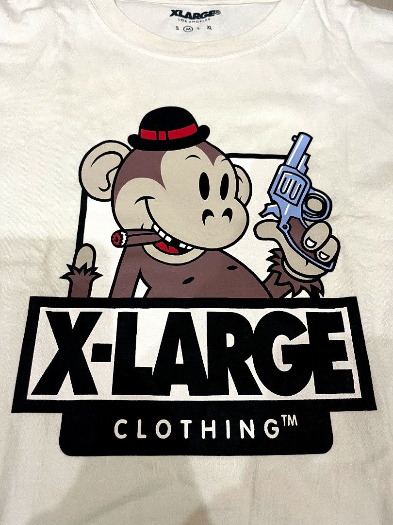 X-Large Graphic Tee White Monkey Gun Cigar Size M (Category: Tshirts & Polo Shirts ) located in Caloocan City. Submitted by bmcfly (Listing ID 1465293863, Image 2). Description: - Brand: X-Large Los Angeles - Color: White - Design: Front graphic of a cartoon monkey with a bowler hat, blue revolver, and cigar, plus bold box logo typography - Fit: Standard fit, ideal for streetwear - Details: Short sleeves, crew neck - Condition: Clean and neat fab