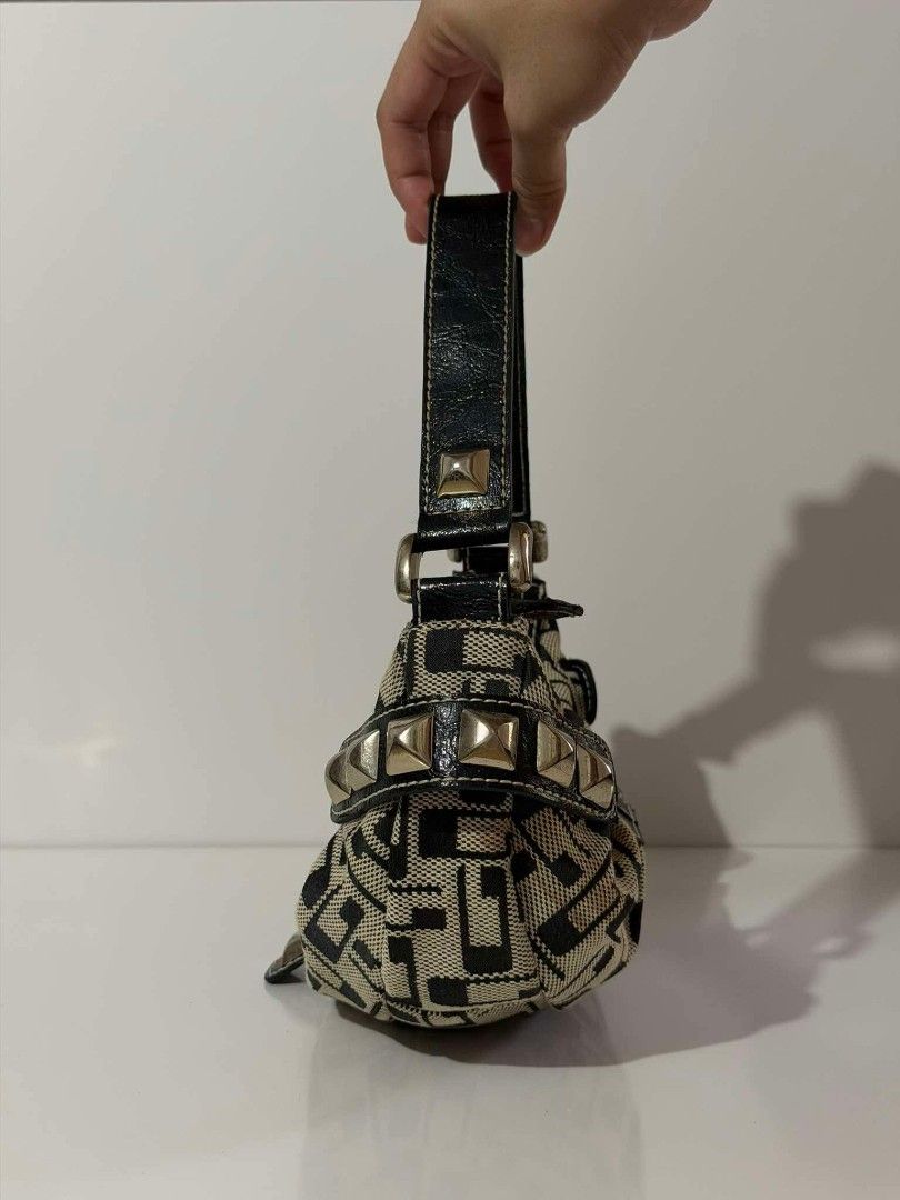 Y2K GUESS MOON SHAPE (Category: Shoulder Bags) located in Manila. Submitted by _louisse (Listing ID 1465354293, Image 3). Description: - Authentic Guess shoulder bag in black and cream monogram canvas - Faux leather trim with chic silver-tone hardware and edgy pyramid studs - Secure front metal lock closure - Trendy leopard print interior lining with a zipped pocket and logo plaque - Comfortable single shoulder strap for easy wear - Condition: Ex