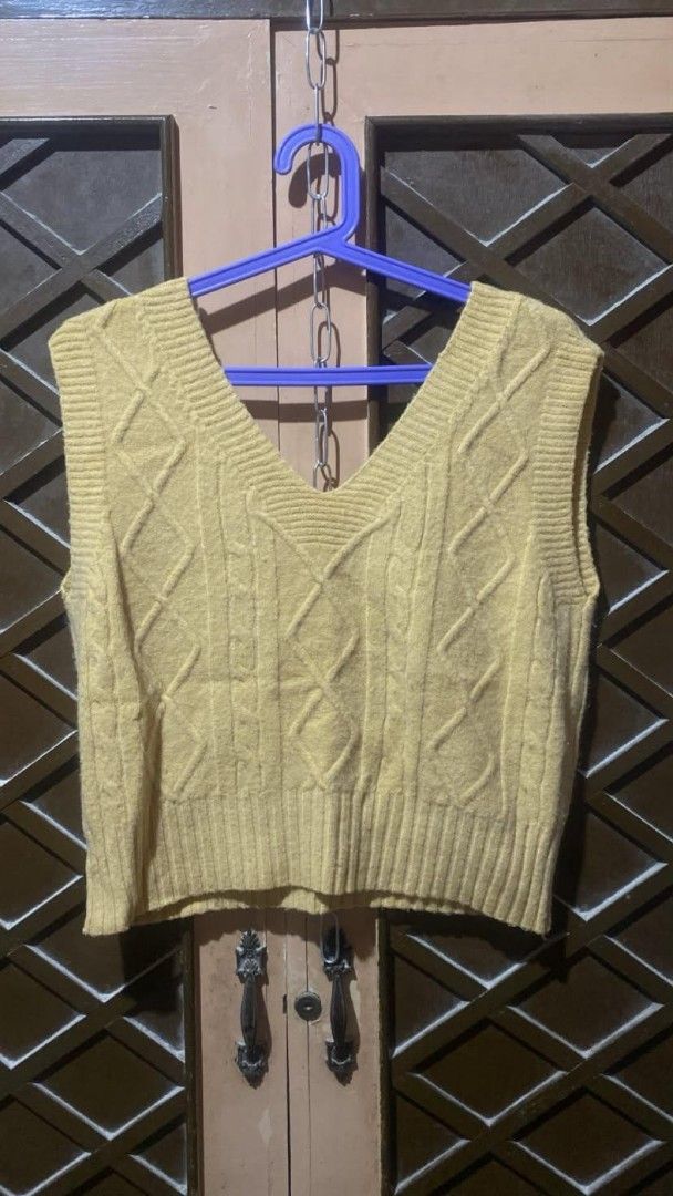 Yellow Cable Knit V-Neck Sweater Vest (Category: Sleeveless) located in Tarlac. Submitted by jieunieee (Listing ID 1465194660, Image 1). Description: - Color: Vibrant yellow - Style: V-neck, sleeveless cable knit sweater vest - Design: Classic diamond pattern on the front with ribbed hem and armholes - Material: Soft and comfortable knit fabric - Versatility: Great for layering over collared shirts or wearing on its own - Condition: Excellent pre