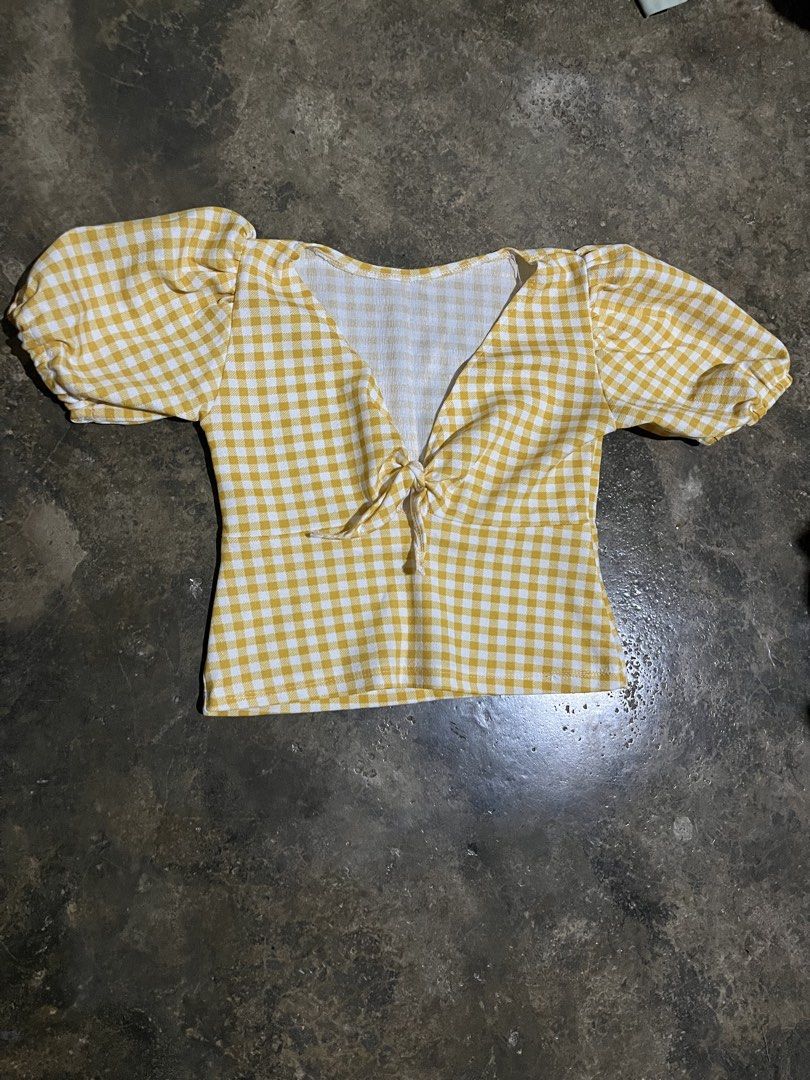 Yellow Gingham Puff Sleeve Tie Front Crop Top (Category: Blouses) located in Nagcarlan. Submitted by young_gfclira (Listing ID 1465172324, Image 1). Description: - Style: Yellow and white gingham check crop top - Details: Short puff sleeves with elastic cuffs, V-neckline with tie-front, and curved back neckline - Material: Comfortable cotton blend.