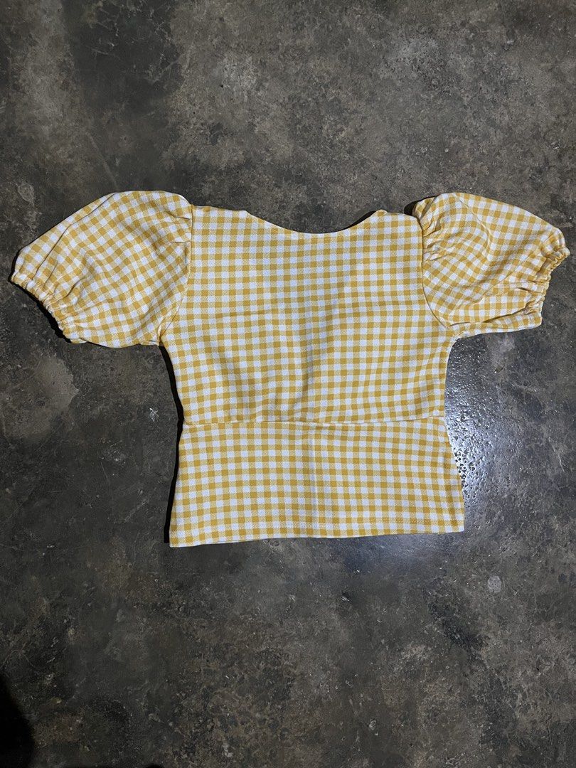 Yellow Gingham Puff Sleeve Tie Front Crop Top (Category: Blouses) located in Nagcarlan. Submitted by young_gfclira (Listing ID 1465172324, Image 2). Description: - Style: Yellow and white gingham check crop top - Details: Short puff sleeves with elastic cuffs, V-neckline with tie-front, and curved back neckline - Material: Comfortable cotton blend.