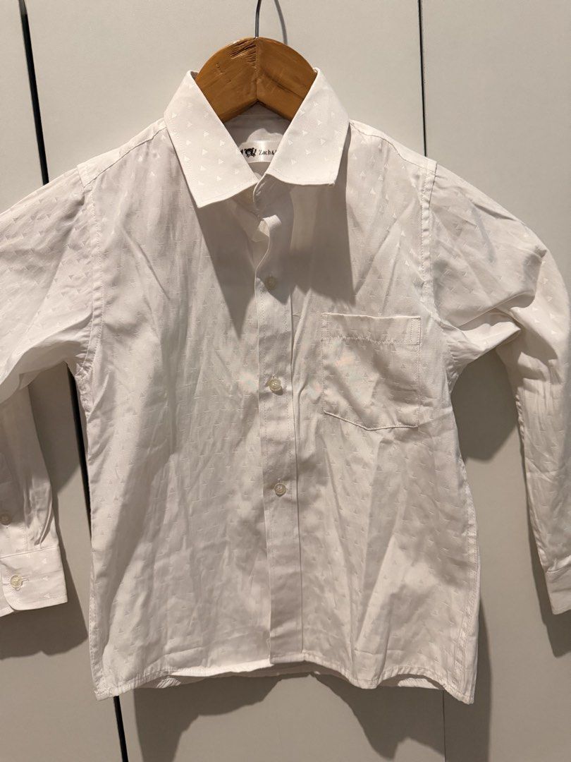 Zach & Mack White Patterned Long Sleeve Shirt Size 6 (Category: Babies & Kids Fashion) located in Las Pinas. Submitted by kleoshop24 (Listing ID 1465210218, Image 1). Description: - Brand: Zach & Mack - Color: White with subtle all-over triangle pattern - Style: Long-sleeve button-down with standard front placket - Details: Left chest pocket, clean collar, and button cuffs - Condition: Excellent, versatile staple piece - Occasion: Ideal for schoo