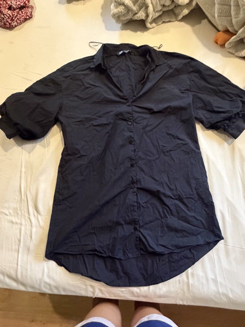 Zara Black Button-Up Shirt Size S (Category: Shirts) located in Quezon City. Submitted by takemythingz (Listing ID 1465215771, Image 1). Description: - Brand: Zara - Size: S (Made in Morocco) - Color: Classic Black - Design: Short puff sleeves with gathered cuffs, classic collar, and front button closure - Details: Pleated upper back and curved, high-low hem - Material: Lightweight fabric, perfect for layering or wearing solo - Condition: Excelle