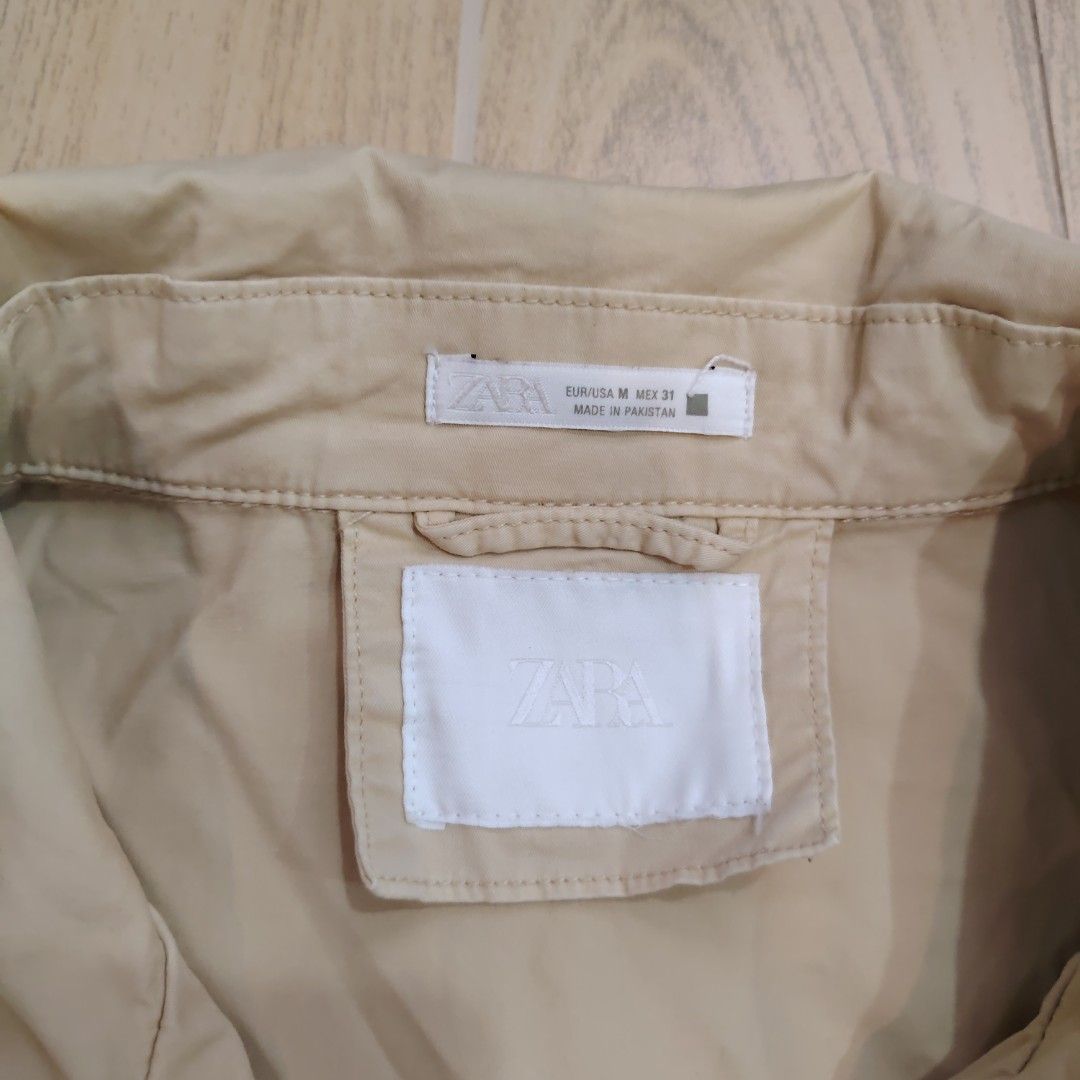 Zara Men Khaki Utility Jacket Size M (Category: Coats, Jackets and Outerwear) located in Quezon City. Submitted by rvco_stuff (Listing ID 1465179293, Image 2). Description: - Brand: Zara - Size: M (Standard fit) - Color: Neutral khaki/beige - Material: Comfortable cotton blend - Origin: Made in Pakistan - Closure: Snap-button front - Pockets: Multiple front and chest utility pockets - Details: Structured collar design - Versatile, goes with every