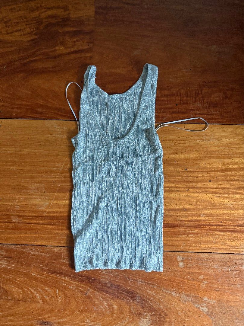 Zara Metallic Silver Ribbed Tank Top Size M (Category: Sleeveless) located in Manila. Submitted by boldcloset (Listing ID 1465220048, Image 2). Description: - Style: Metallic silver ribbed tank top with low U-back - stretchy material ! - Size: M - Condition: Good, with a small flaw (see photo) never been used, bought with minor flaw RFS: wrong size .