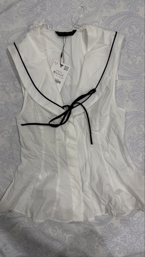 Zara Sailor Collar Black Tie White Blouse (Category: Blouses) located in Davao. Submitted by tswizzleeess (Listing ID 1465156568, Image 2). Description: Zara Sleeveless top with sailor collar and black tie closure Fits XS to Small Brand new with original tags attached, never worn. Message me for detailed photos if you want! ☺️ RFS: Decluttering 📍Davao City 💳 GCash, Bank Transfer (BDO) 📦 LBC, J&T SF shouldered by the buyer 😊.