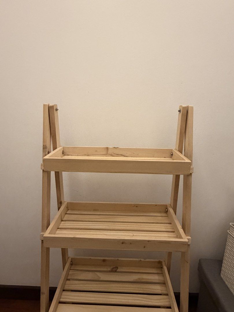 4-Tier Wooden Rack / Display Shelf (Category: Other Home Furniture) located in Mandaluyong City. Submitted by meowwth (Listing ID 1467091872, Image 2). Description: Selling my wooden 4-tier rack in very good condition! * No issues; well-maintained * not being used anymore Dimensions: * Height: 45 inches * Width: 21.5 inches * Depth: 13 inches Price: ₱1,200, negotiable. Buyer may arrange pickup or delivery at their expense. Message me if intereste