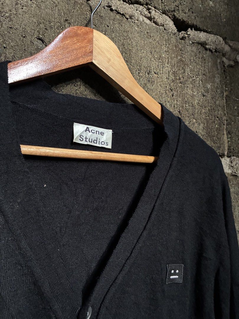 Acne Studios College Face Wool Cardigan Black (Category: Longsleeves) located in Manila. Submitted by assortedgoodsv3 (Listing ID 1467165741, Image 3). Description: - Brand: Acne Studios - Item: Black wool cardigan - Size: Large (L) - Material: 100% wool knit (lightweight & warm) - Design: V-neck, front button closure, ribbed cuffs & hem - Detail: Signature face logo patch on the left chest - Condition: Clean, tags intact.