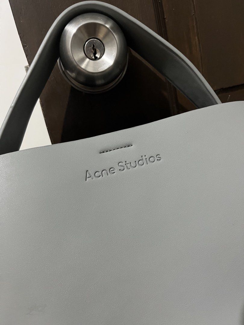 Acne Studios Grey Musubi Mini Bag (Category: Luxury Bags & Wallets) located in Mabalacat. Submitted by onlygrail.pamp (Listing ID 1467143030, Image 2). Description: - Brand: Acne Studios - Color: Grey - Material: Premium Leather - Condition: Barely any signs of wear (Pristine) - Hardware: Gold-tone with signature studs - Exterior: Clean front debossed logo lettering & signature knotted sides - Interior: Center zippered compartment divider and sna
