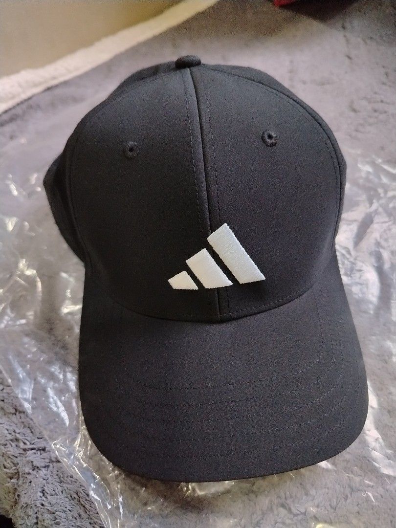 Adidas Black Cap with White Logo (Category: Caps & Hats) located in Rizal. Submitted by zhellieme (Listing ID 1467036878, Image 1). Description: - Brand: Adidas - Color: Black with white embroidered logo - Condition: Brand new with original tags attached - Design: Classic six-panel cap with breathable top eyelets - Fit: Adjustable strap at the back with a metal buckle - Material: Clean, high-quality fabric finish.