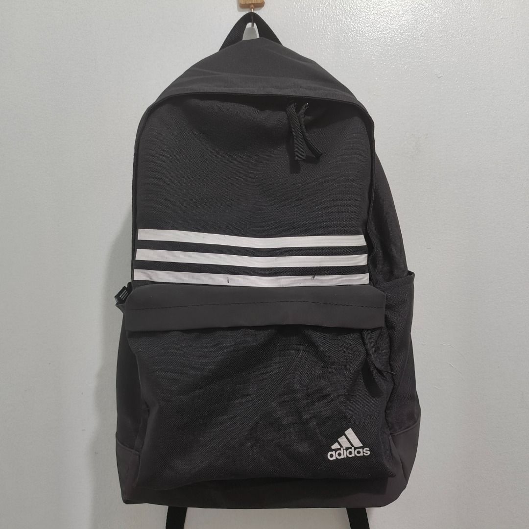 PREOWNED Adidas Classic 3-Stripes Pocket Backpack Black (Category: Backpacks) located in Manila. Submitted by blackhaven98 (Listing ID 1467055244, Image 1). Description: - Authentic black Adidas backpack with classic white stripes and branding - Storage includes a spacious zippered main compartment and a front pocket - Comfort features adjustable padded shoulder straps with an Adidas logo patch - Size: Medium (tag verified) - Country of origin: P