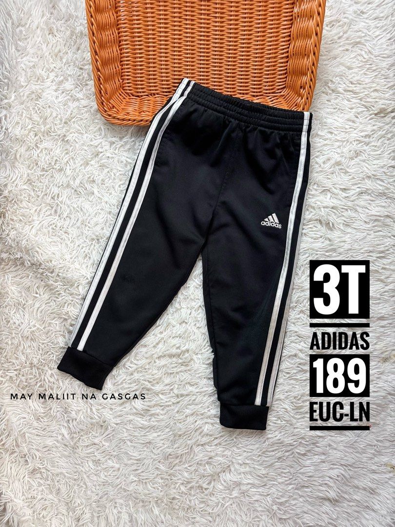 Adidas Kids Track Pants Size 3T (Category: Babies & Kids Fashion) located in Quezon City. Submitted by rosemyamar (Listing ID 1467067287, Image 1). Description: - Brand: Adidas - Color: Black with classic white three stripes - Size: Toddler 3T - Design: Elastic waistband, small hip logo, and fitted ankle cuffs - Condition: Good, with a tiny scratch mark near the leg area - Perfect for: Everyday play and comfort.