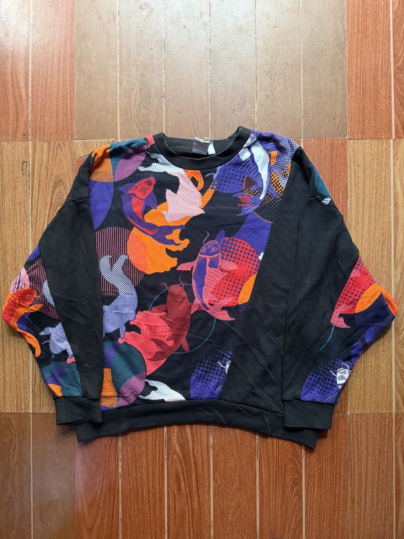 Adidas Koi Fish Print Graphic Sweatshirt (Category: Coats, Jackets and Outerwear) located in Dasmarinas. Submitted by kylebecker (Listing ID 1467001122, Image 1). Description: - Brand: Adidas Originals - Color: Black with vibrant Japanese koi fish graphic - Design: Long sleeves with solid black front panels, crewneck collar - Details: Embroidered Trefoil logo near the chest, ribbed cuffs and hem - Fit: Soft and comfortable for everyday casual wea