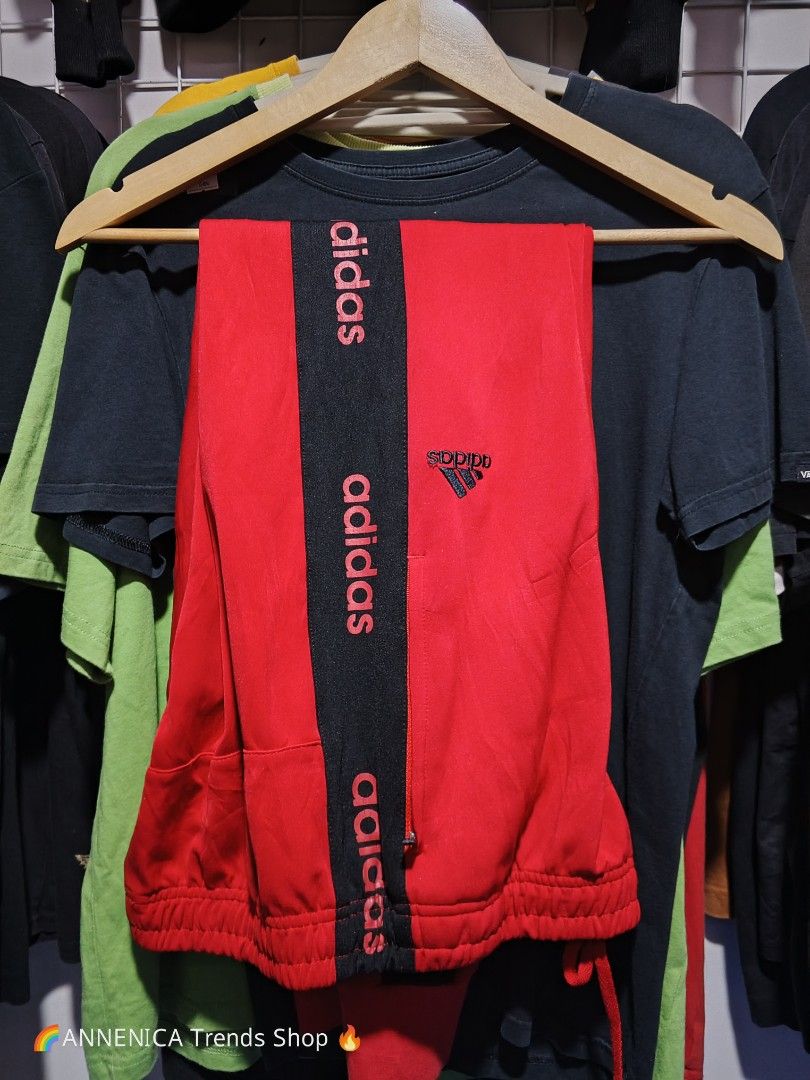 ADIDAS Taped Track Pants (Category: Joggers) located in Bulacan. Submitted by annenicathriftthriftlang (Listing ID 1467007708, Image 1). Description: 🔴 ADIDAS Taped Track Pants - Red/Black 🔴 Size: XXL on tag (Fits XL-XXL) Color: Red with Black side tape 📏 DIMES: Waist 36-40 garter + drawstring Length 41" Inseam 30" ✅ DETAILS: - Embroidered Adidas logo (not print!) - Side tape with repeating ADIDAS wordmark - Zippered side pockets (functional!)