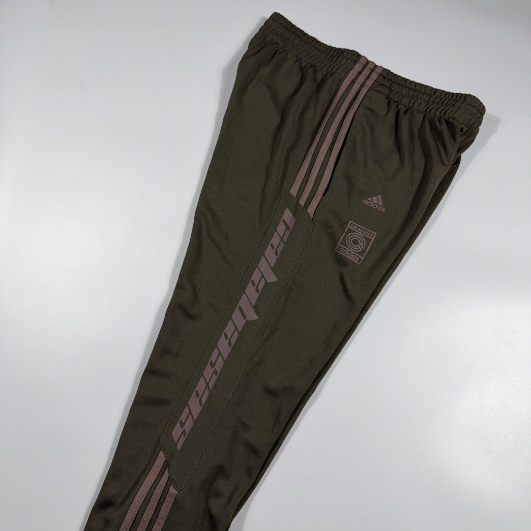 Adidas Yeezy Calabasas Track Pants (Category: Joggers) located in Bacolod City. Submitted by freshstuff13 (Listing ID 1467057038, Image 3). Description: Authentic Adidas Yeezy Calabasas track pants - Colorway: Earth Green - Condition: 10/10, clean with no flaws on fabric or prints - Features: Classic three-stripes, secure zippered side pockets, elastic waistband, and ribbed ankle cuffs - Branding: Signature Calabasas text print - Material: Soft, 