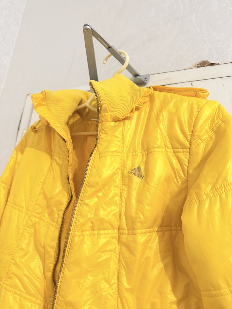 Adidas Yellow Puffer Jacket (Category: Coats, Jackets and Outerwear) located in Cebu City. Submitted by cutexoxoshop (Listing ID 1466973372, Image 1). Description: - Vibrant bright yellow color - Quilted padding with a tall ribbed collar - Full front zipper closure - Distinctive metallic gold Adidas logo on the chest - Lightweight, weather-resistant outer shell - Ideal for cooler weather and everyday wear.