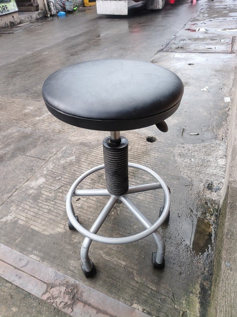 Adjustable rolling stool black seat silver base (Category: Chairs) located in Valenzuela. Submitted by kendra071914 (Listing ID 1466993326, Image 2). Description: - Condition: Brand New/Excellent - Adjustable height: 53cm to 66cm with easy-to-use lever - Comfortable round black padded seat (35cm diameter) - Sturdy silver metal frame with a built-in circular footrest ring - Smooth-rolling 5 caster wheels for easy mobility - Sleek center post with 