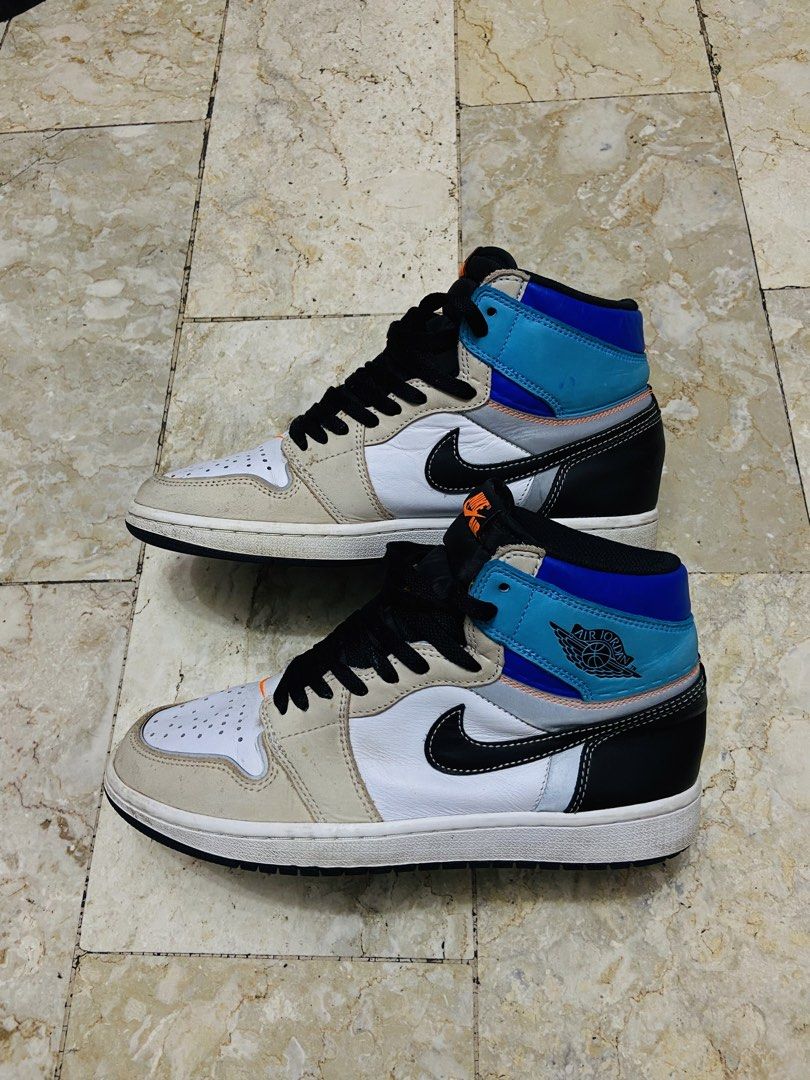 Air Jordan 1 Retro High OG Prototype (Category: Sneakers) located in Manila. Submitted by supersergio (Listing ID 1467018876, Image 2). Description: - Model: Air Jordan 1 Retro High OG Prototype - Size: US 8.5 / UK 7.5 / EUR 42 - Colorway: White base, beige overlays, black swoosh, blue ankle collar with orange accents - Condition: Normal usage wear on suede panels and midsoles; clean outsoles and solid structure intact - Ideal for: Everyday rotat