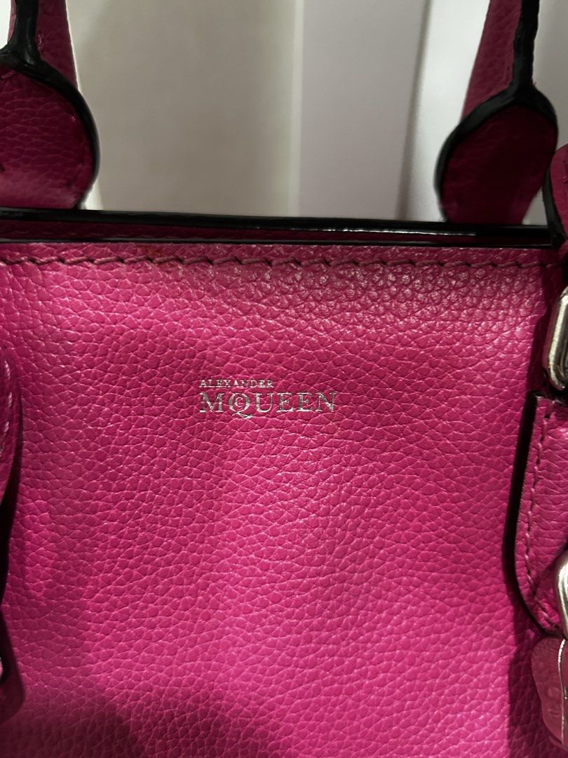 Alexander McQueen Pink Leather Satchel Handbag (Category: Luxury Bags & Wallets) located in Rizal. Submitted by bebangel (Listing ID 1467101812, Image 3). Description: Vibrant pink pebbled leather satchel from Alexander McQueen. Silver hardware throughout, including the signature skull padlock charm hanging from the front. Dual top handles and a detachable shoulder strap for carrying options. Leather clochette with keys attached. Stamped silver l