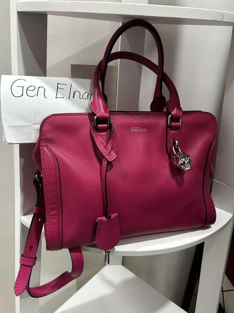 Alexander McQueen Pink Leather Satchel Handbag (Category: Luxury Bags & Wallets) located in Rizal. Submitted by bebangel (Listing ID 1467101812, Image 2). Description: Vibrant pink pebbled leather satchel from Alexander McQueen. Silver hardware throughout, including the signature skull padlock charm hanging from the front. Dual top handles and a detachable shoulder strap for carrying options. Leather clochette with keys attached. Stamped silver l