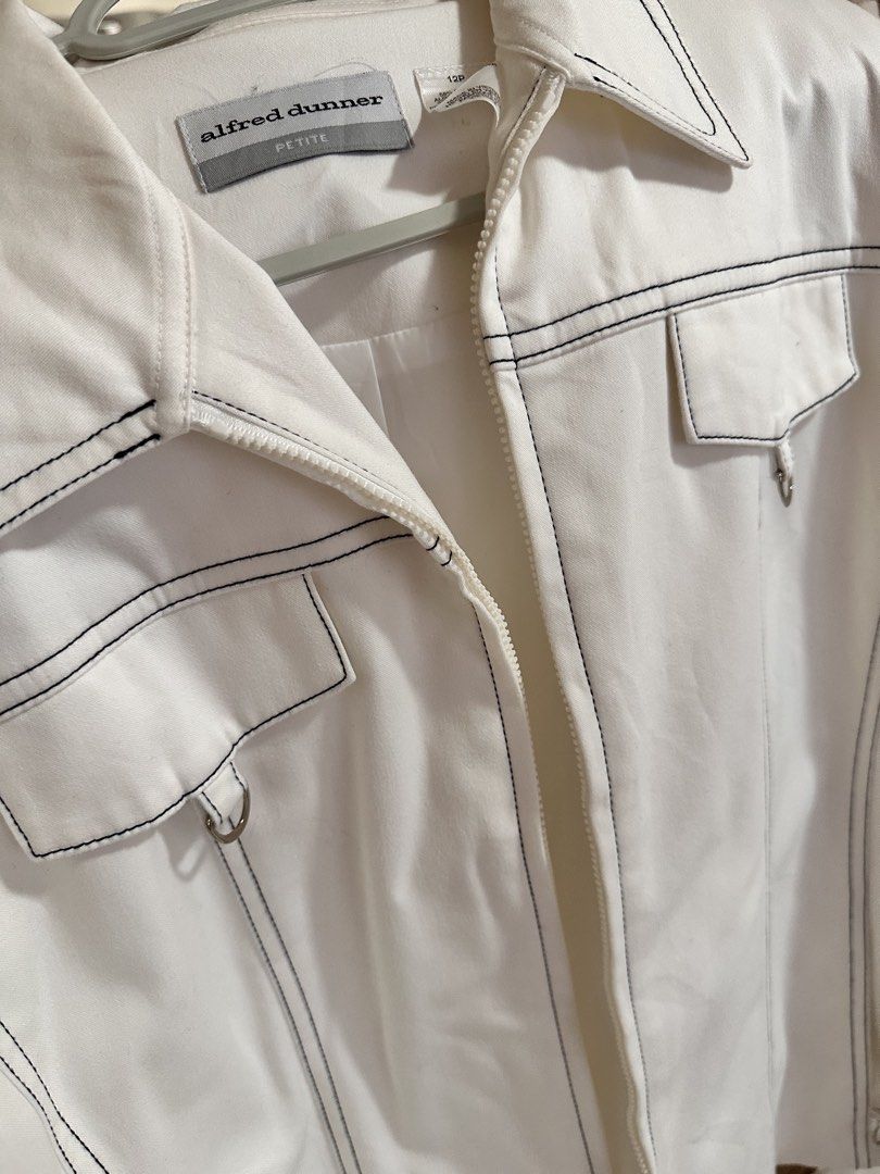 Alfred Dunner Petite White Contrast Stitch Zip Jacket (Category: Coats, Jackets and Outerwear) located in Paranaque City. Submitted by moonbea (Listing ID 1467041051, Image 2). Description: - Brand: Alfred Dunner - Size: Petite 12P - Color: Crisp white with contrasting dark stitching - Closure: Full front zipper with collar - Pockets: Two chest flap pockets with metal ring accents - Fit: Structured tailoring with front and back panel seams.