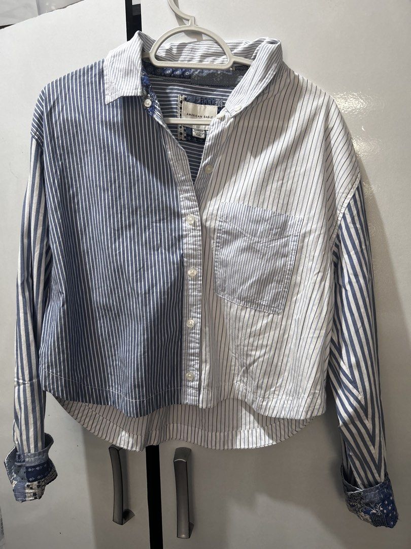 American Eagle Mixed-Striped Cropped Shirt (Category: Longsleeves) located in Pasig City. Submitted by ladyleslieisletavelarde4902 (Listing ID 1466974431, Image 1). Description: A unique patchwork-inspired long-sleeve button-down featuring contrast vertical stripes, patterned cuff trims, and a trendy relaxed cropped hemline. Brand: American Eagle Tag Size: XS Recommended Fit: Fits XS to Small comfortably due to the relaxed/oversized crop cut Fabr