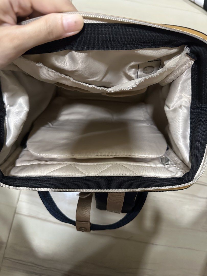 Anello Navy Blue Backpack (Category: Backpacks) located in Manila. Submitted by alyxxelijah (Listing ID 1467084733, Image 3). Description: - Storage: Spacious main compartment, front zippered pocket, and internal slip pockets. Laptop compartment (Mac air) - Condition: Sturdy and clean overall, with fraying along the top interior pocket hem.